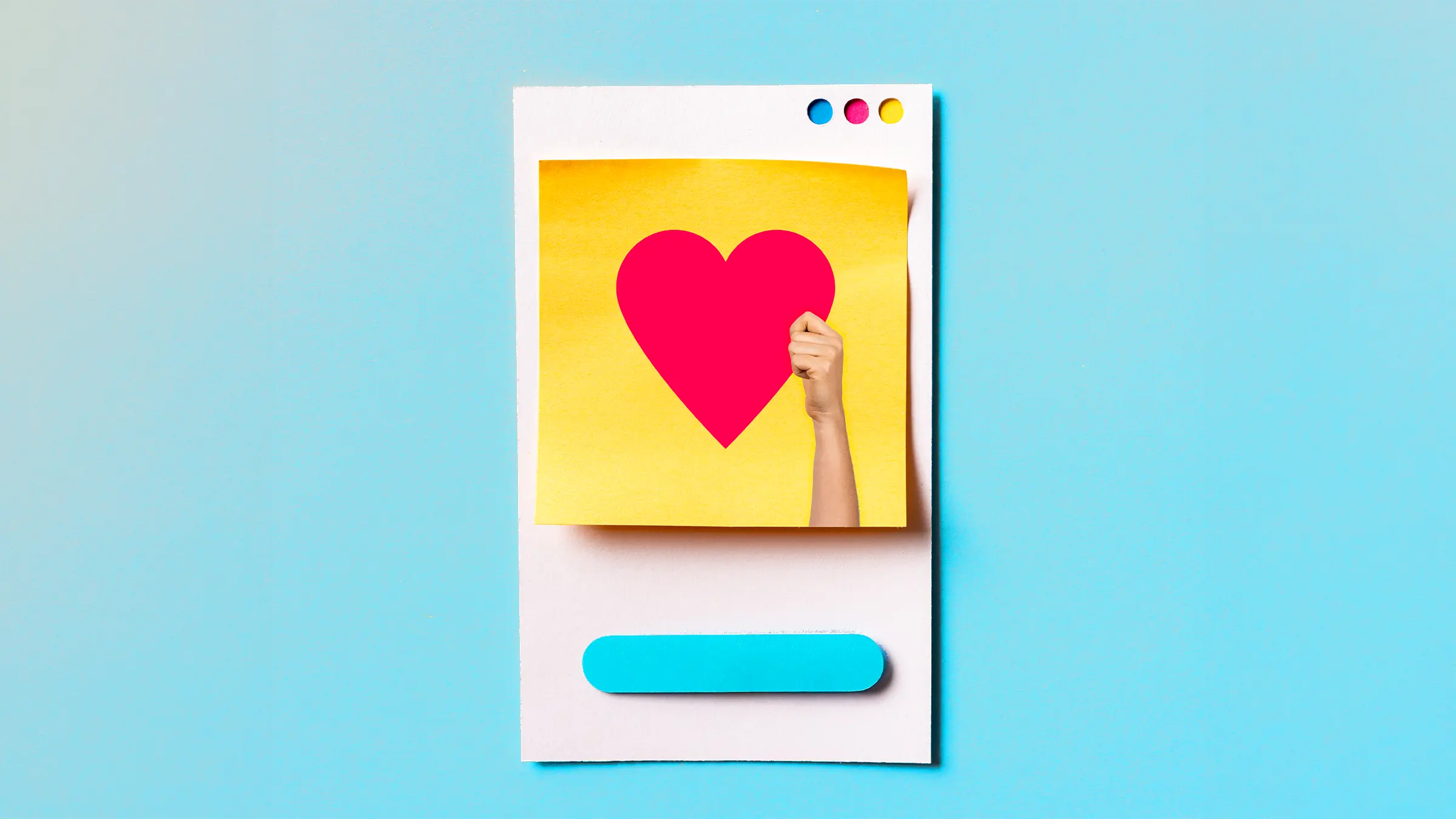 Papier-Imitat eines Social-Media-Postings auf einem Smartphone, auf dem eine Hand ein rotes Herz nach oben hält