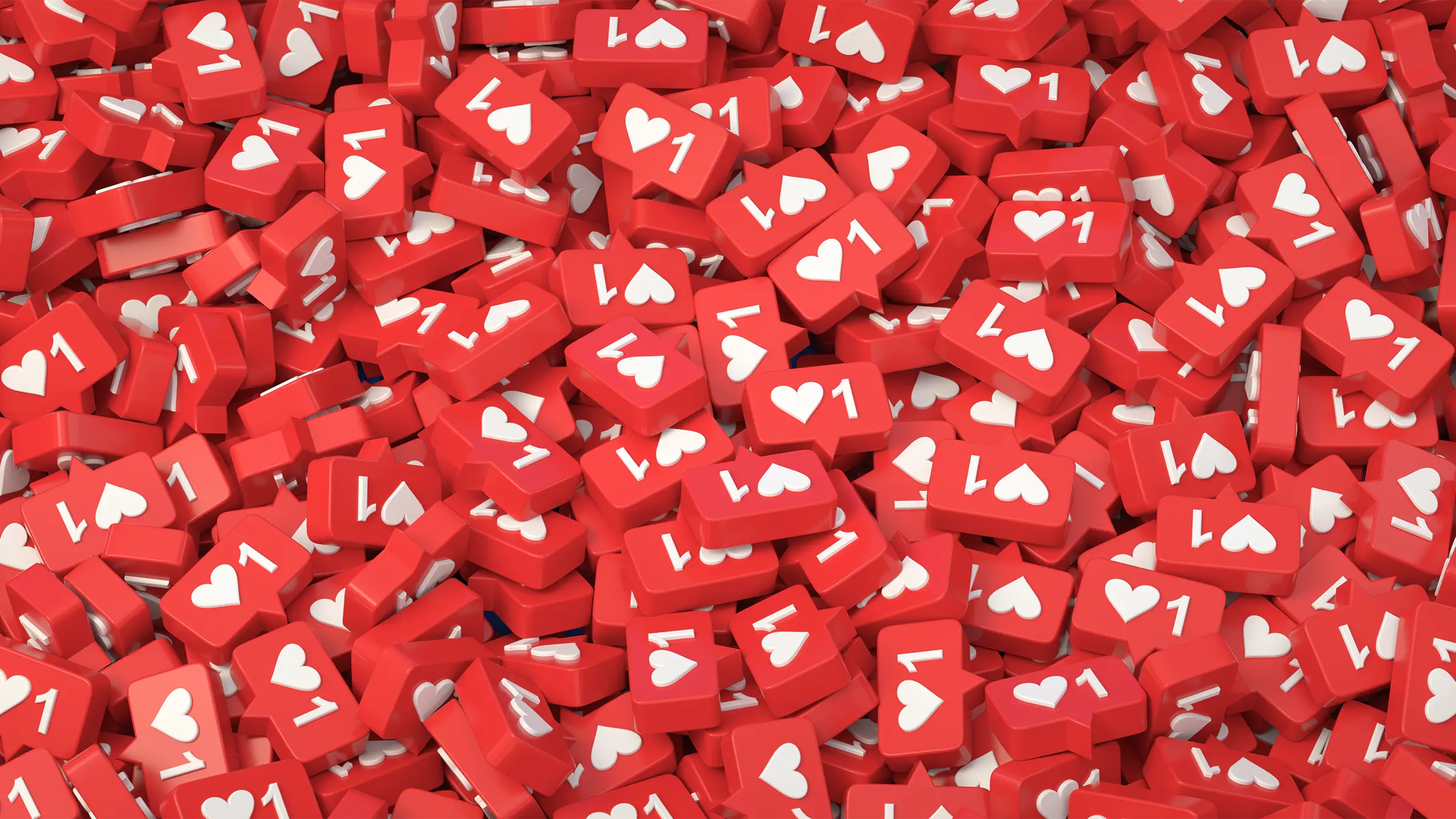 Ein Haufen kleiner roter Sprechblasen mit dem klassischen Like-Symbol in den sozialen Medien